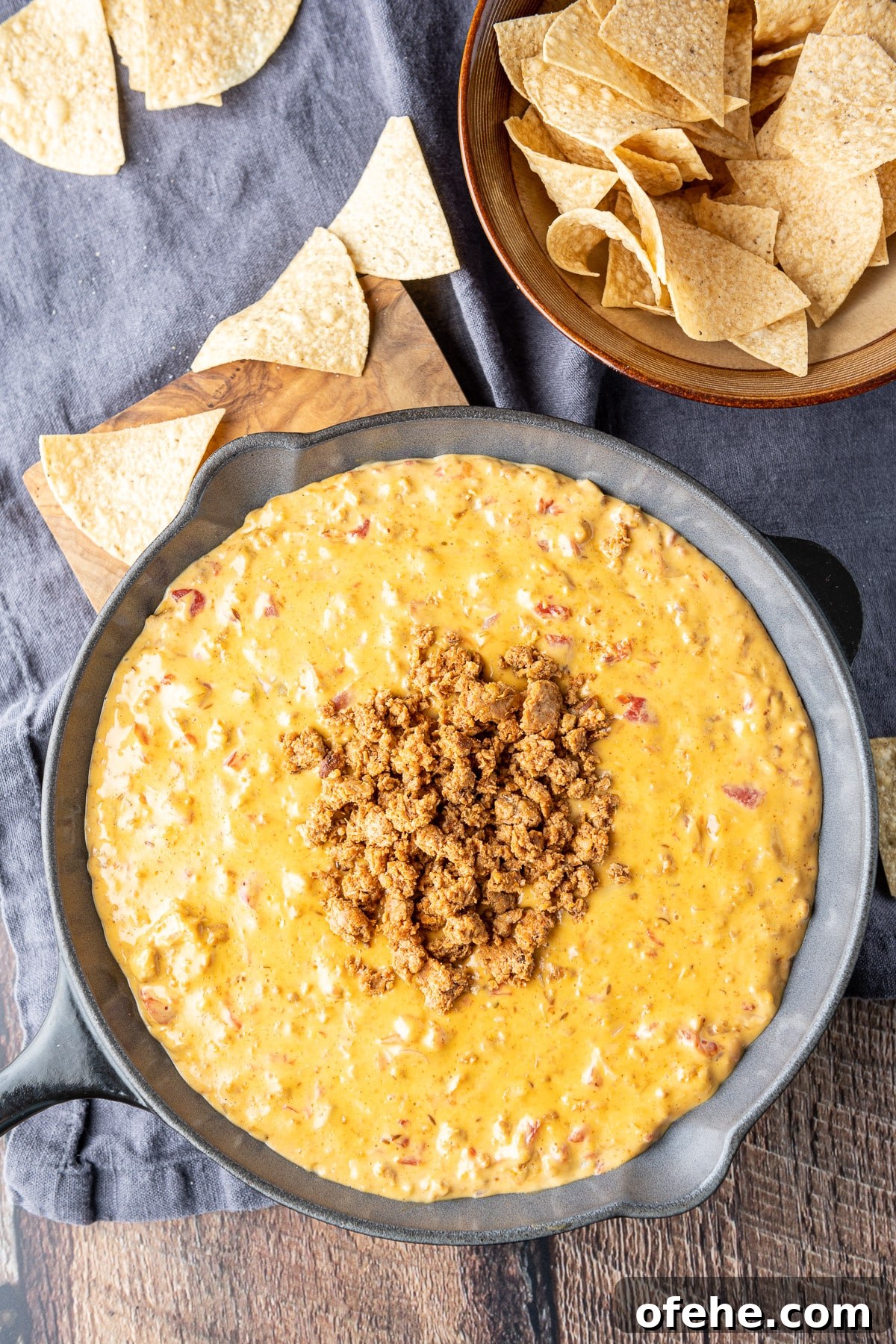 Creamy Chorizo Dip Recipe for Game Day or Parties 8 Overhead view of the spicy dip with chips strewn on the table
