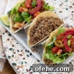 Classic Ground Beef Tacos: Grandma’s 60-Year Family Recipe 10 Three tacos on a taco holder