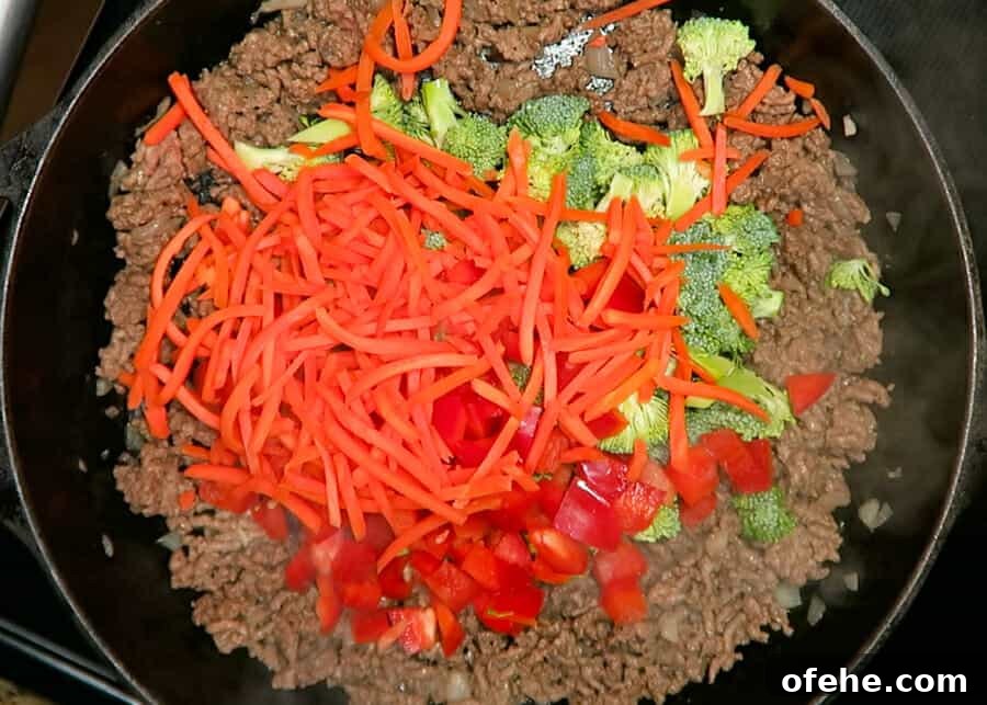 30-Minute Korean Ground Beef Stir-Fry Recipe (One-Pot) 7 veggies being added to the skillet
