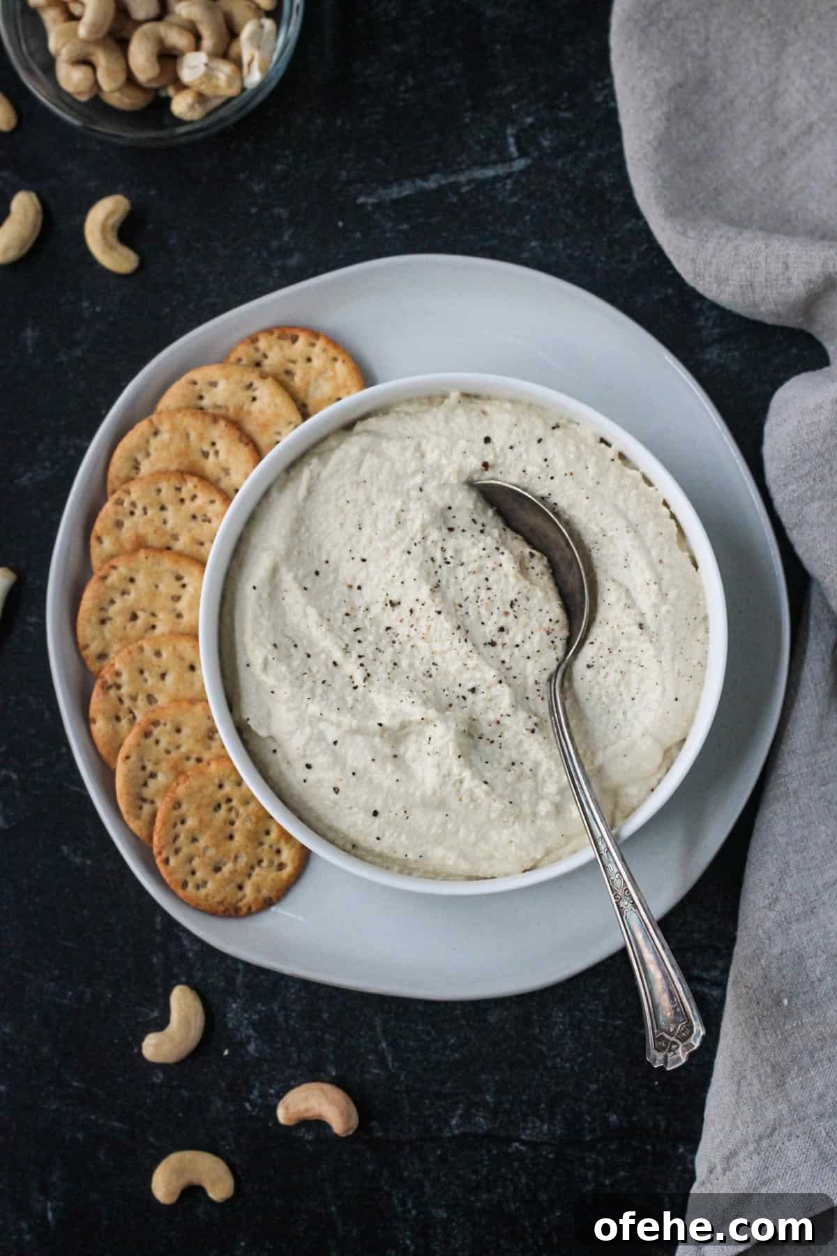 Creamy Vegan Cashew Ricotta Recipe for Pasta & Pizza 2 Vegan ricotta in a serving bowl on a plate with crackers.