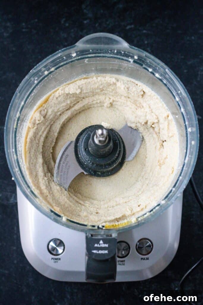 Creamy Vegan Cashew Ricotta Recipe for Pasta & Pizza 5 Creamy vegan ricotta spread in a food processor.