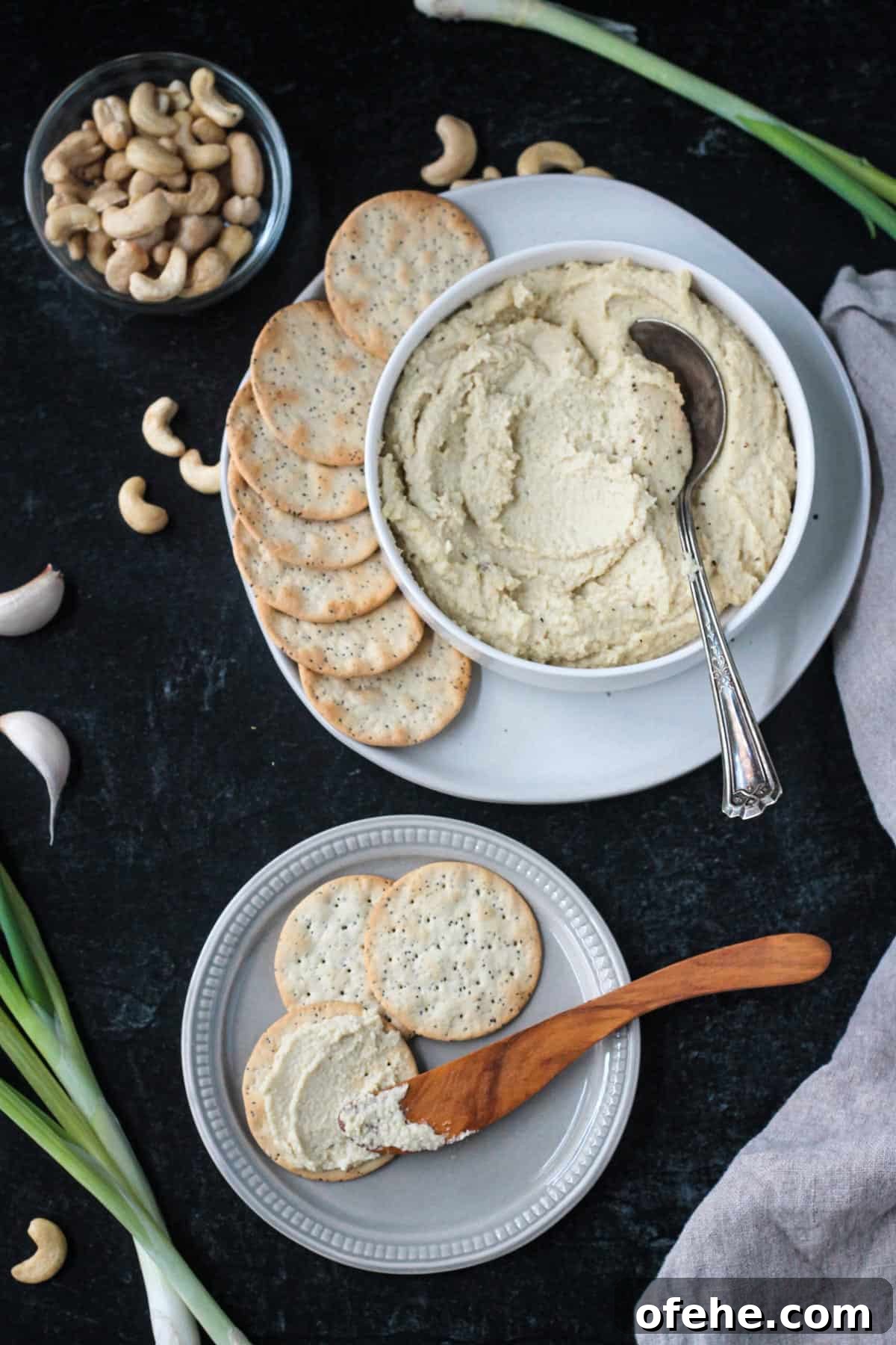 Creamy Vegan Cashew Ricotta Recipe for Pasta & Pizza 7 Bowl of ricotta spread next to a plate of crackers.