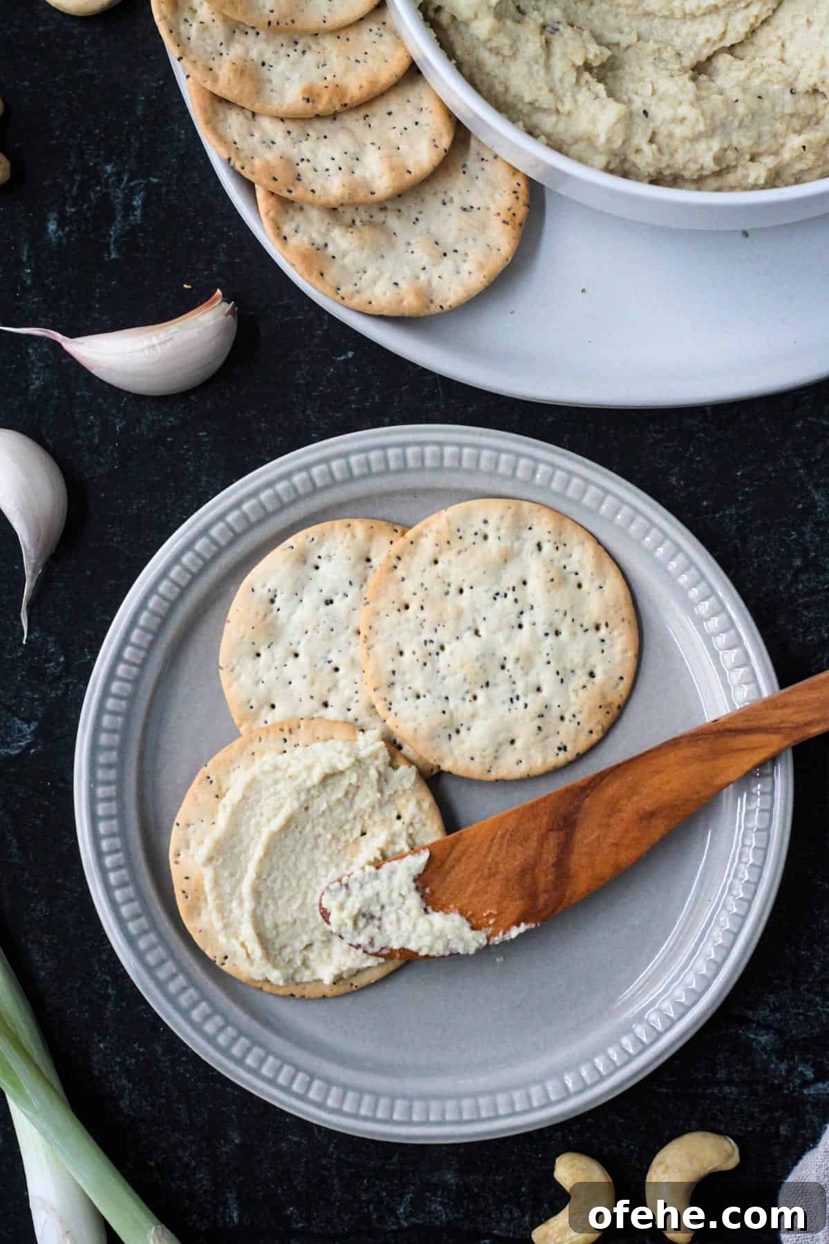 Creamy Vegan Cashew Ricotta Recipe for Pasta & Pizza 8 Ricotta spread on one cracker next to two plain crackers.