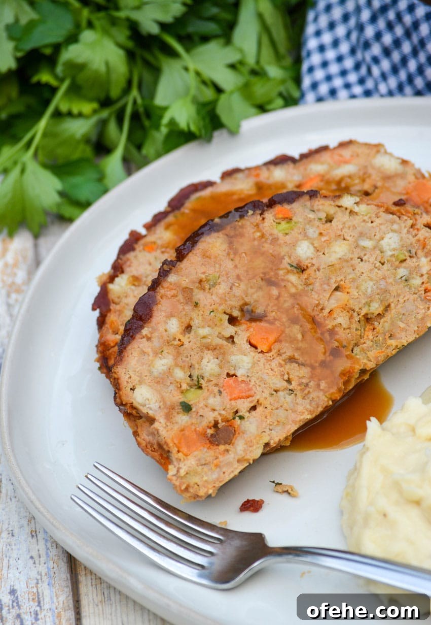two slices of thanksgiving meatloaf on a white dinner plate 