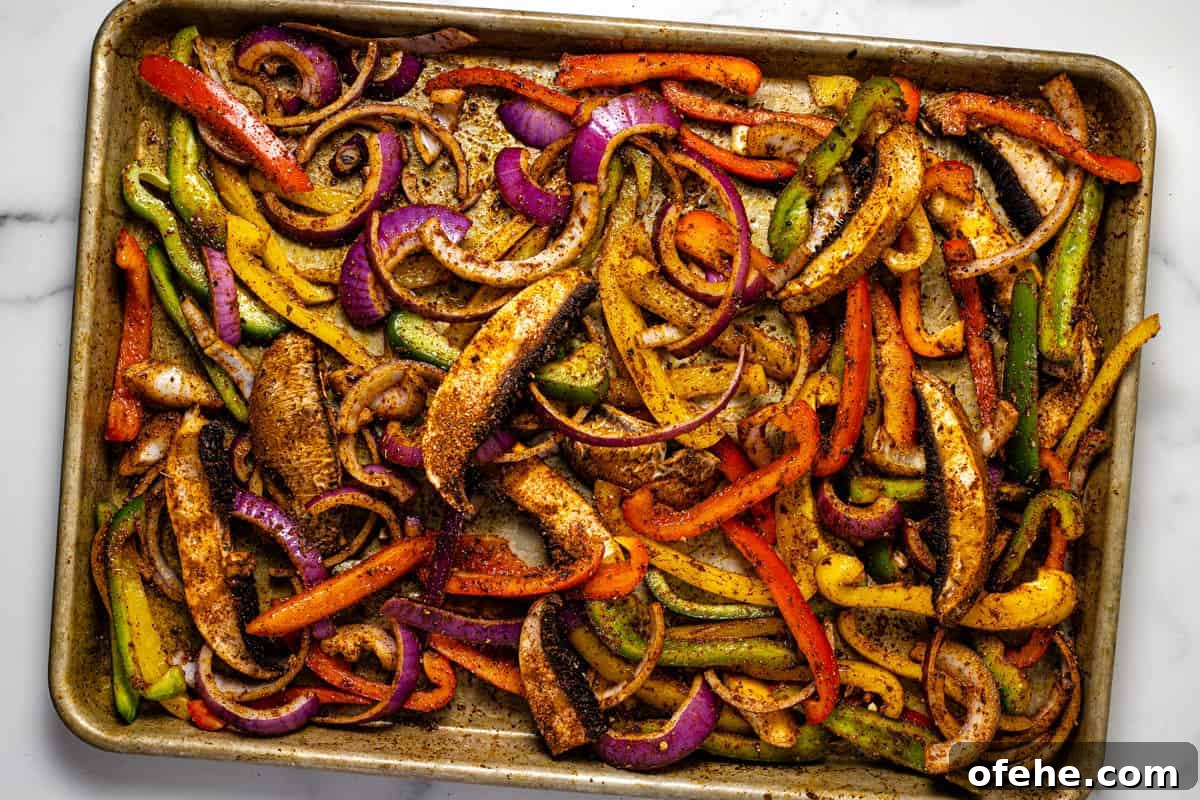 Oven-Baked Fajita Vegetables with Bell Peppers and Onions 6 Baking sheet filled with fajita veggies ready to go in the oven