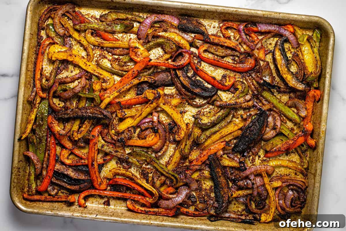 Oven-Baked Fajita Vegetables with Bell Peppers and Onions 7 Baking sheet filled with oven baked fajita veggies