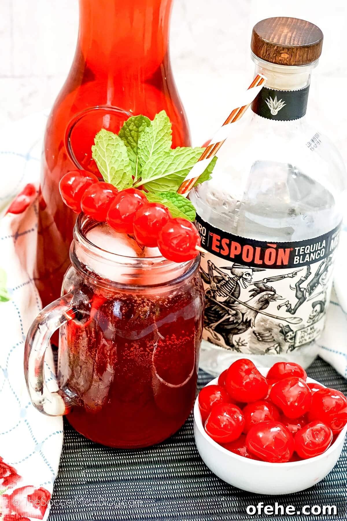 Tipsy Texan Cocktail Recipe: How to Make the Signature Texan Drink 7 mason jar cocktail with bottle of tequila and carafe of cranberry juice