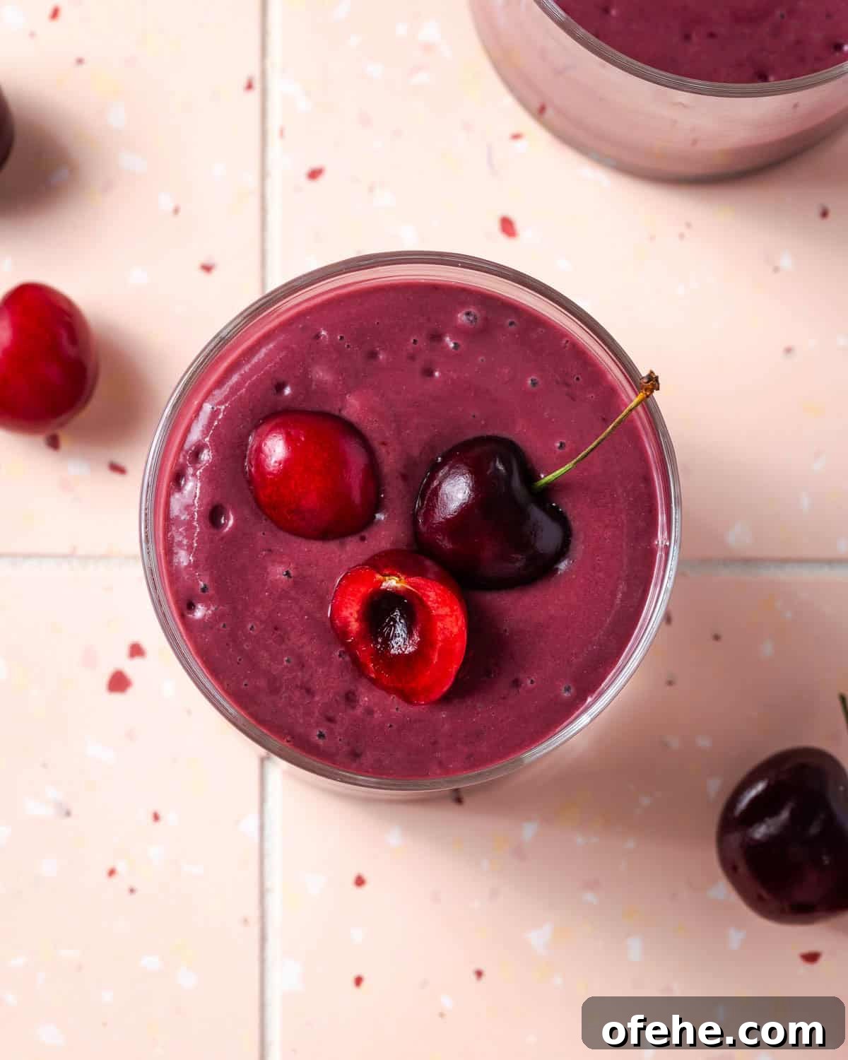 Creamy Cherry Smoothie Recipe for Fresh, Fruity Mornings 2 A cherry smoothie topped with a few fresh cherries.