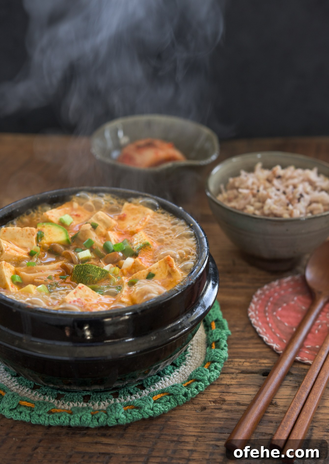 Authentic Doenjang Jjigae Recipe: Classic Korean Soybean Paste Stew 2 Authentic Doenjang Jjigae (Korean Soybean Paste Stew) bubbling in a traditional stone pot.