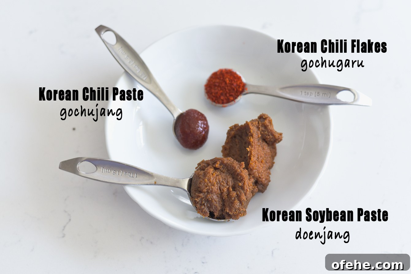 Authentic Doenjang Jjigae Recipe: Classic Korean Soybean Paste Stew 4 Doenjang, gochujang, and gochugaru prepared for making Korean stew