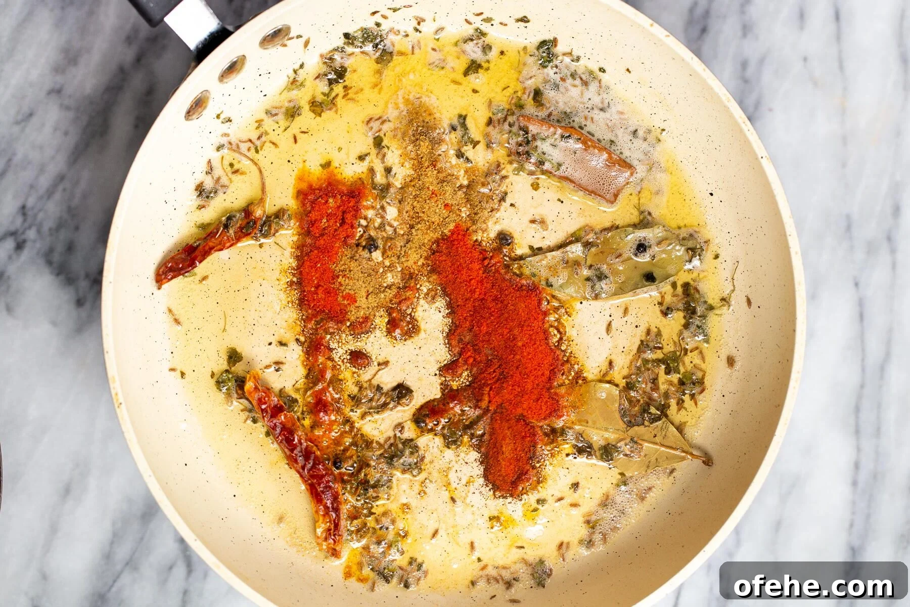ground spices being added to tempering for dal recipe