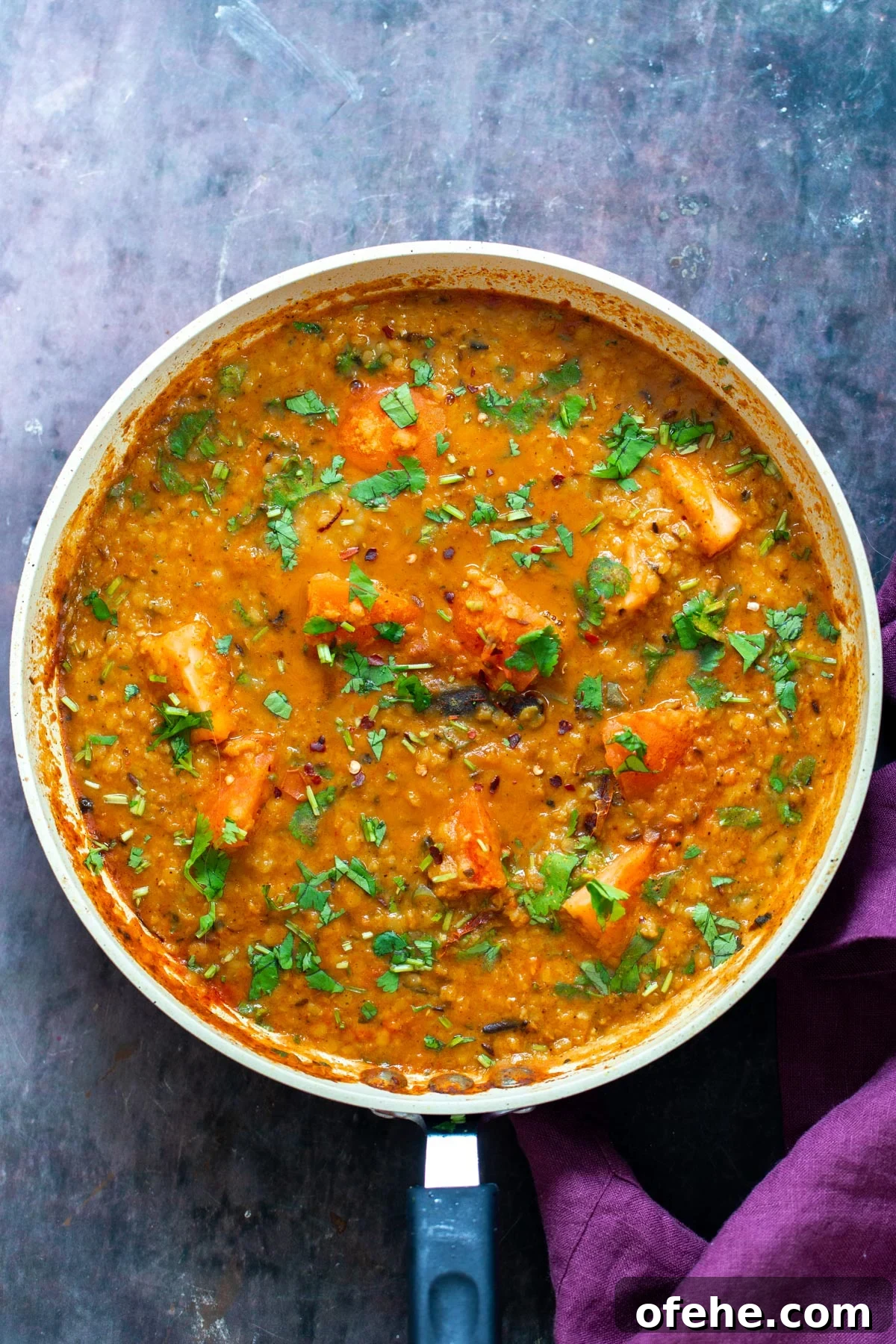 a pan with vegan butter dal sprinkled with cilantro 
