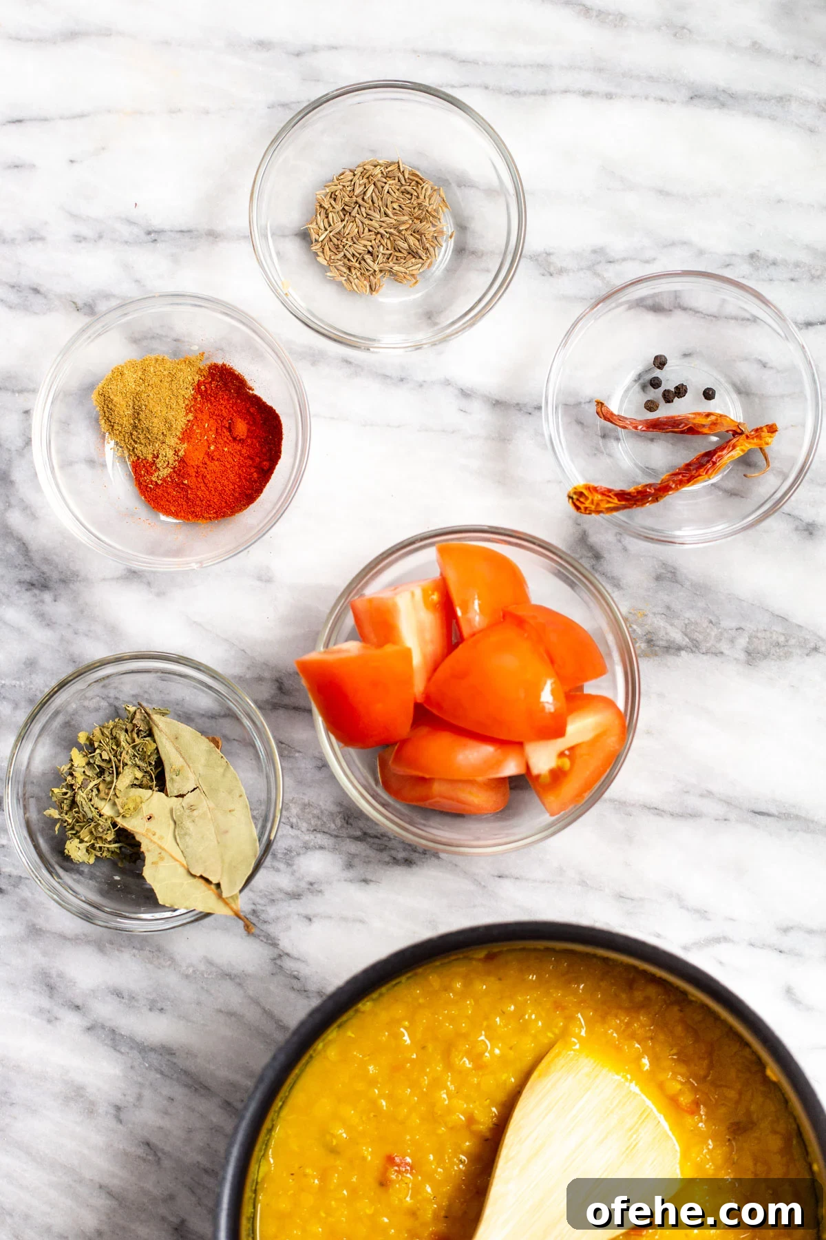 ingredients for making butter daal on a marble surface