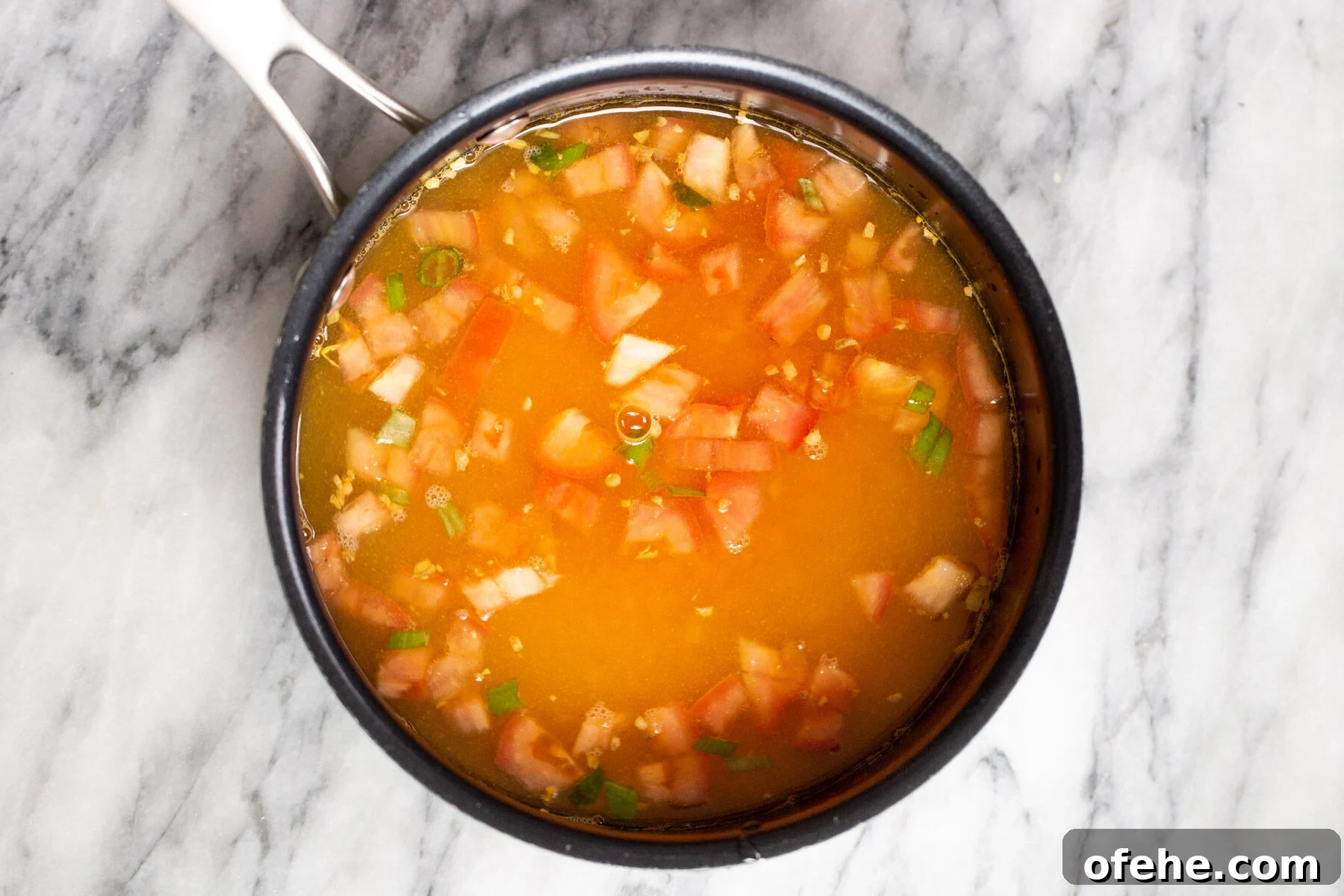 a pot with tomatoes and red lentils 