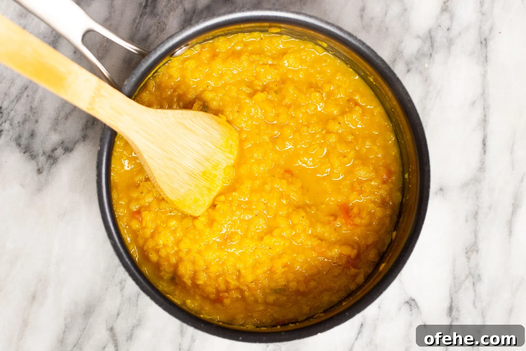 red lentils being cooked in a pot 