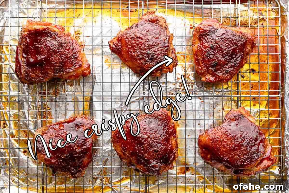 Juicy Baked BBQ Chicken Thighs with Crispy Skin 13 baked bbq chicken thighs on rack with text overlay