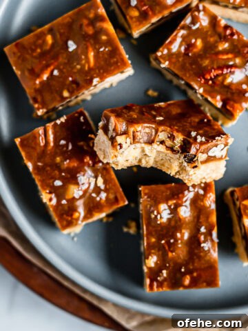 Caramel pecan bars on a blue plate.