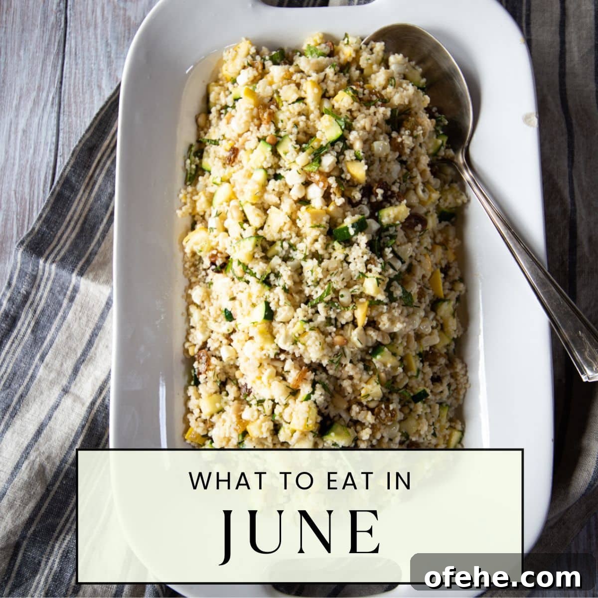A serving dish heaped with summer couscous with zucchini, summer squash, and raisins.