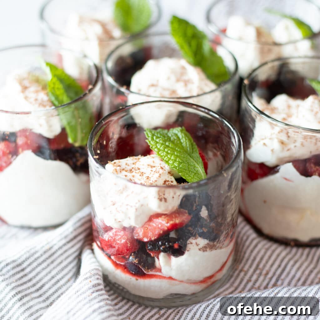 Glasses of layered berries and cream.
