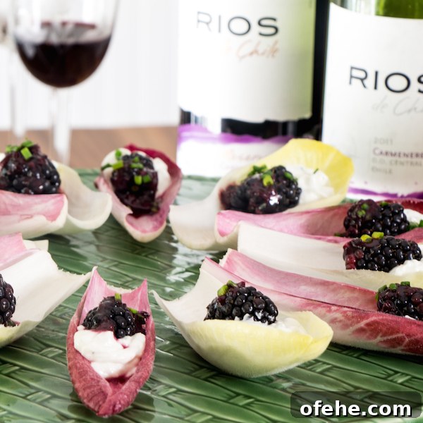 Endive leaves filled with blue cheese and blackberries.
