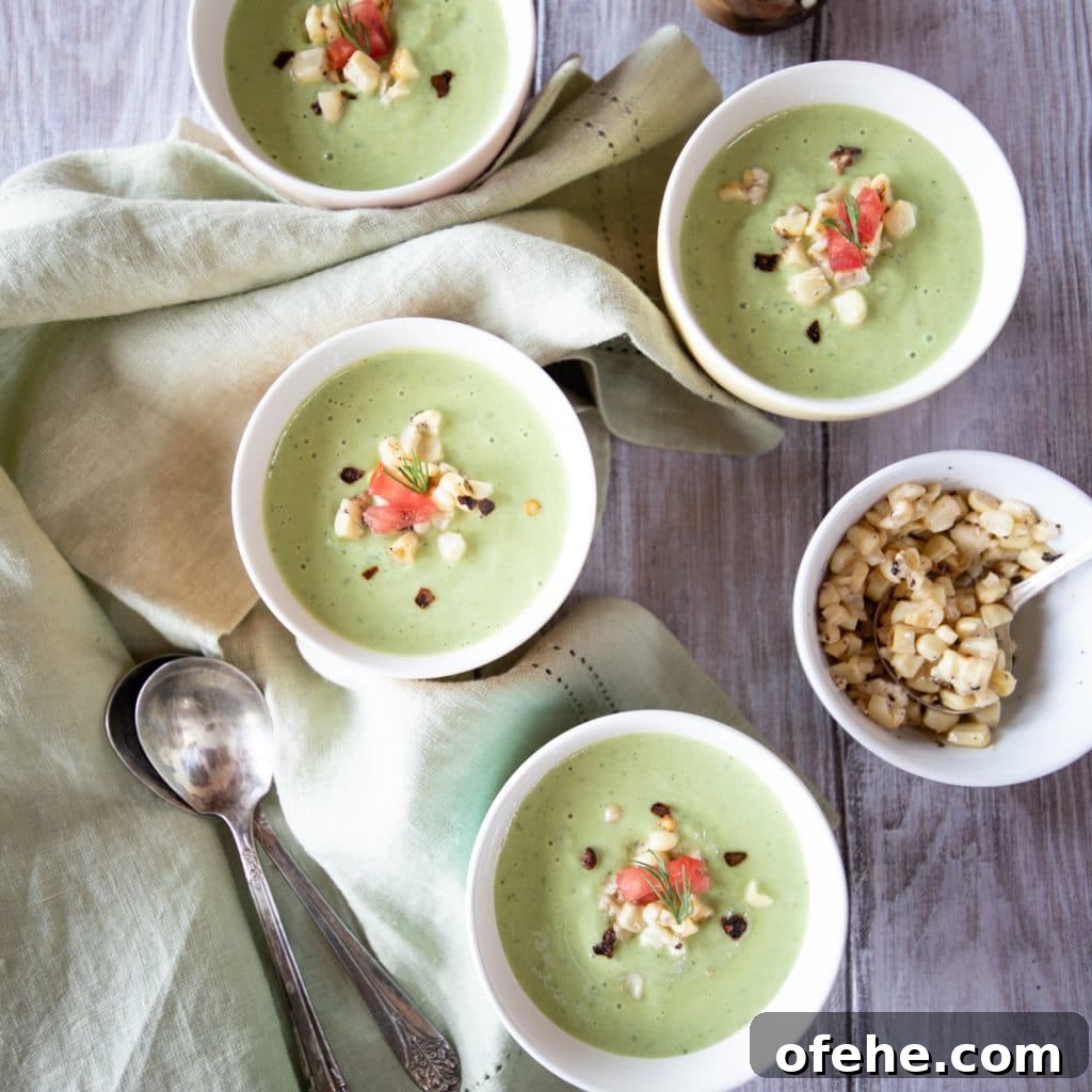 Bowls of chilled cucumber soup with garnishes.