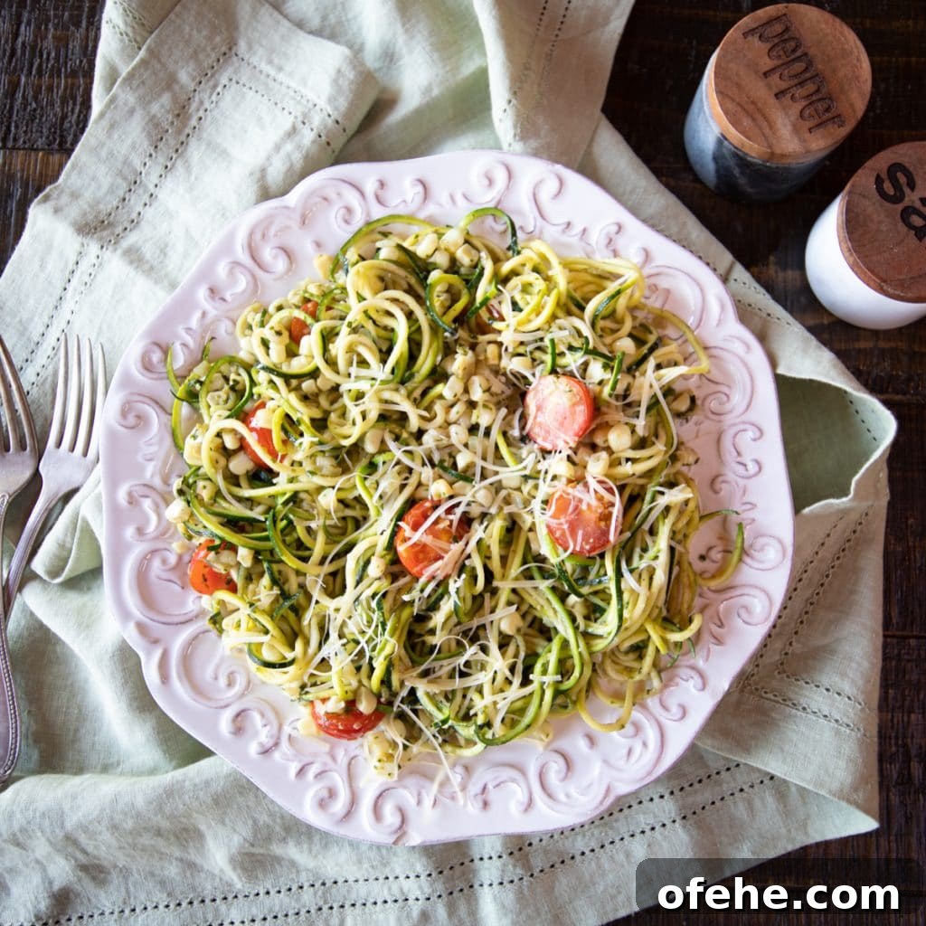 Zucchini noodles with corn and tomatoes in pesto.