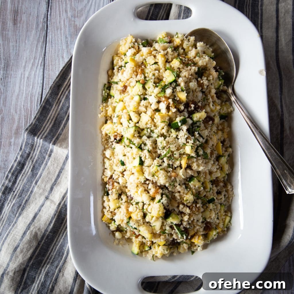 Summer couscous salad with zucchini, corn, raisins and pine nuts.