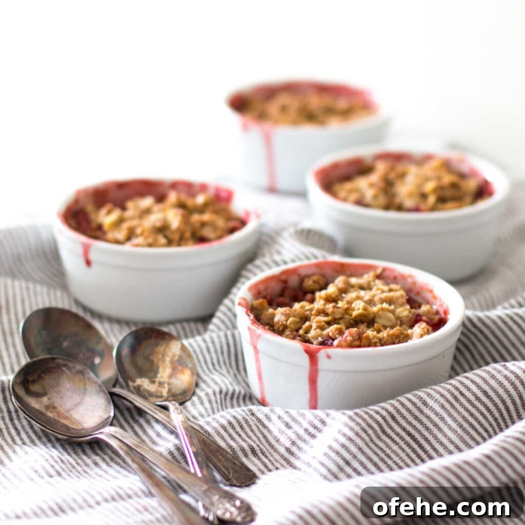 Four mini strawberry rhubarb crisps.