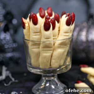 Spooky Witch Finger Cookie Recipe for Halloween Treats 11 Witch Finger Cookies standing upright in a clear glass.