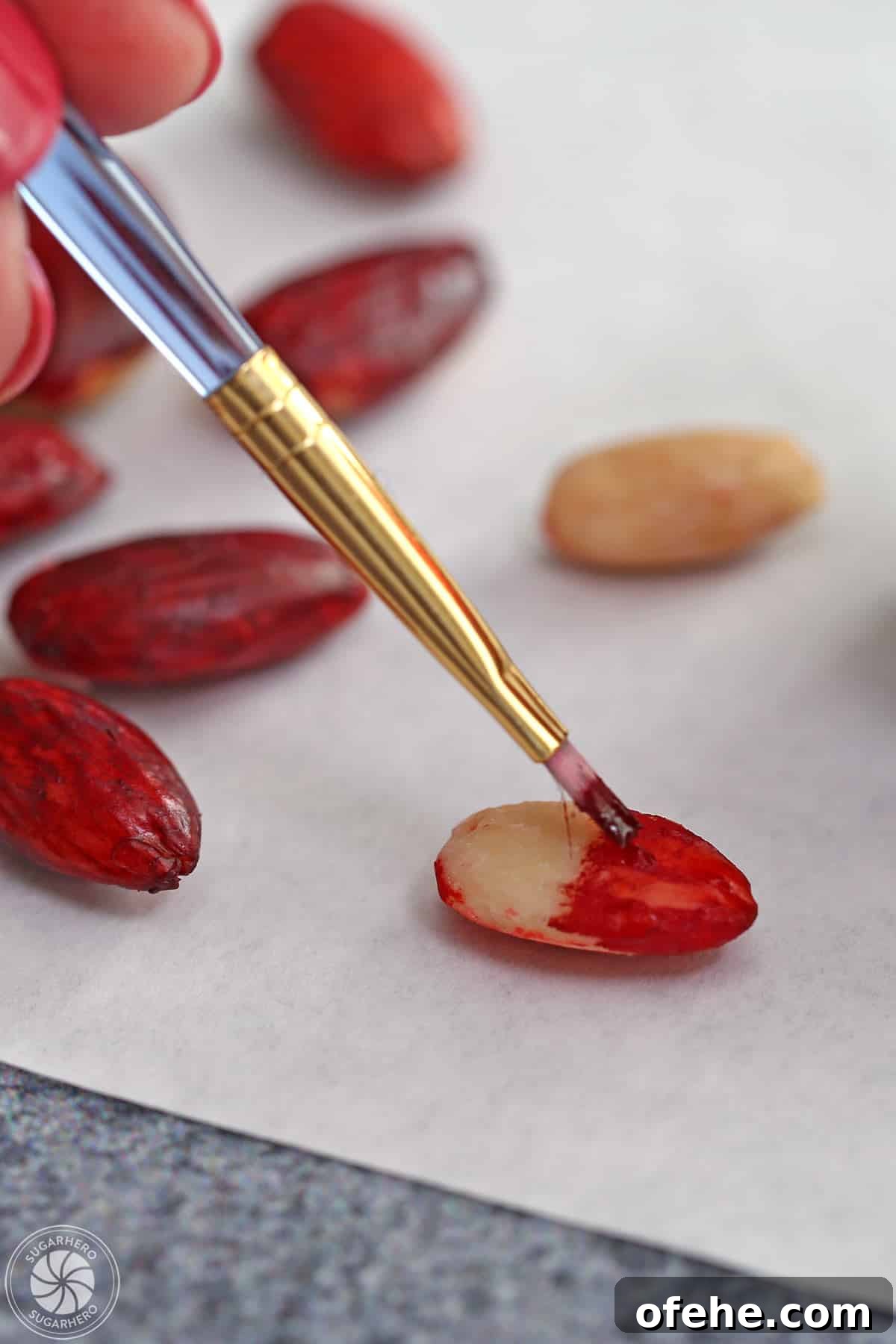 Spooky Witch Finger Cookie Recipe for Halloween Treats 14 Painting a blanched almond with red food coloring.