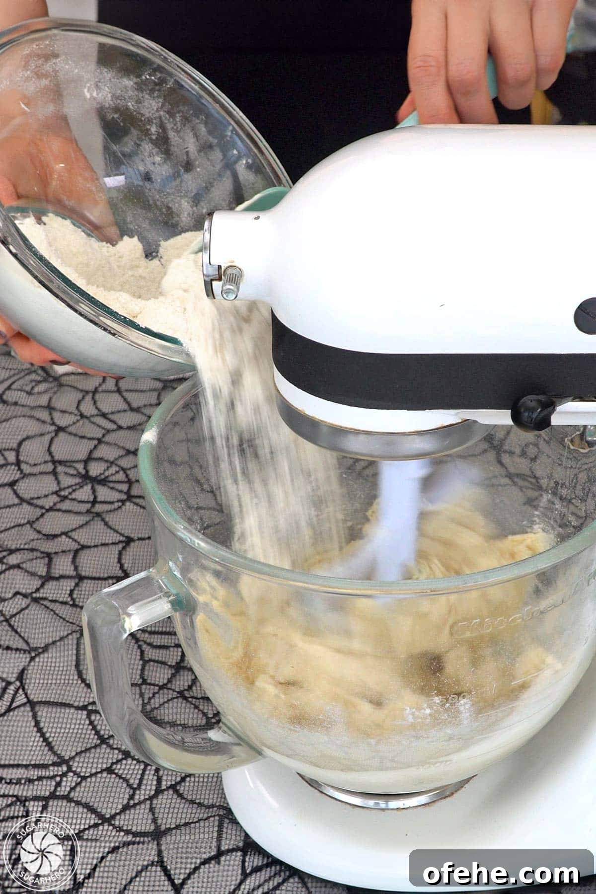 Spooky Witch Finger Cookie Recipe for Halloween Treats 18 Pouring flour into glass mixing bowl to make witch finger cookies.