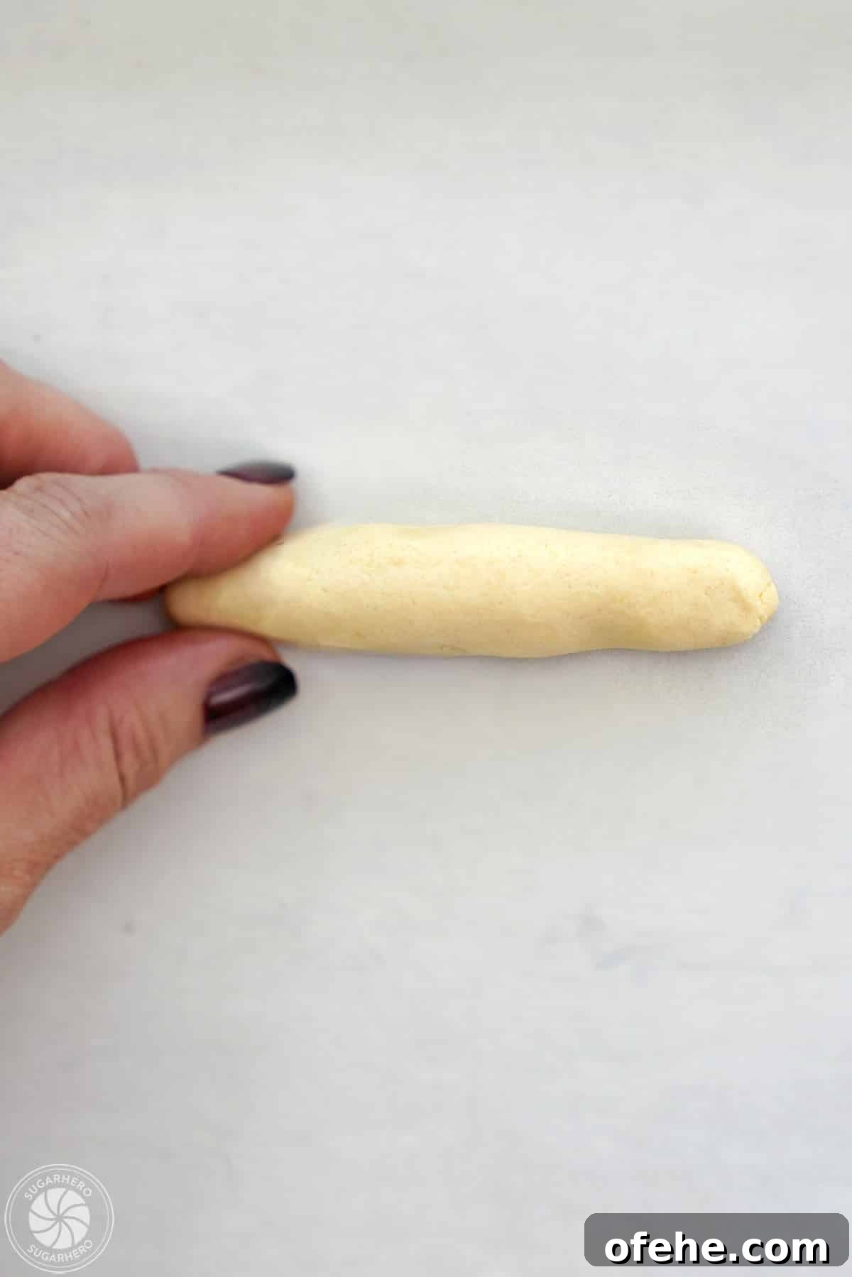 Spooky Witch Finger Cookie Recipe for Halloween Treats 20 Shaping shortbread dough into a cylinder to make witch finger cookies.