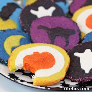 Spooky Witch Finger Cookie Recipe for Halloween Treats 24 Plate of baked Slice and Bake Halloween Cookies with a bite taken out of the front cookie.