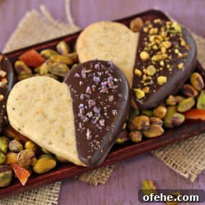 Spooky Witch Finger Cookie Recipe for Halloween Treats 25 Close up of 3 Pistachio Shortbread Cookies on a bed of pistachios.
