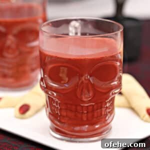 Spooky Witch Finger Cookie Recipe for Halloween Treats 6 Clear skull-shaped mug full of red velvet hot chocolate.