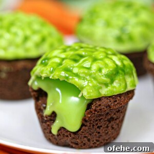 Spooky Witch Finger Cookie Recipe for Halloween Treats 8 Close up of oozing Zombie Brain Brownie Bite on a plate with several more brownie bites in the background.