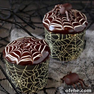 Spooky Witch Finger Cookie Recipe for Halloween Treats 9 Close up of 2 Spiderweb Cupcakes and 2 chocolate spiders with giant black spiders in the background.