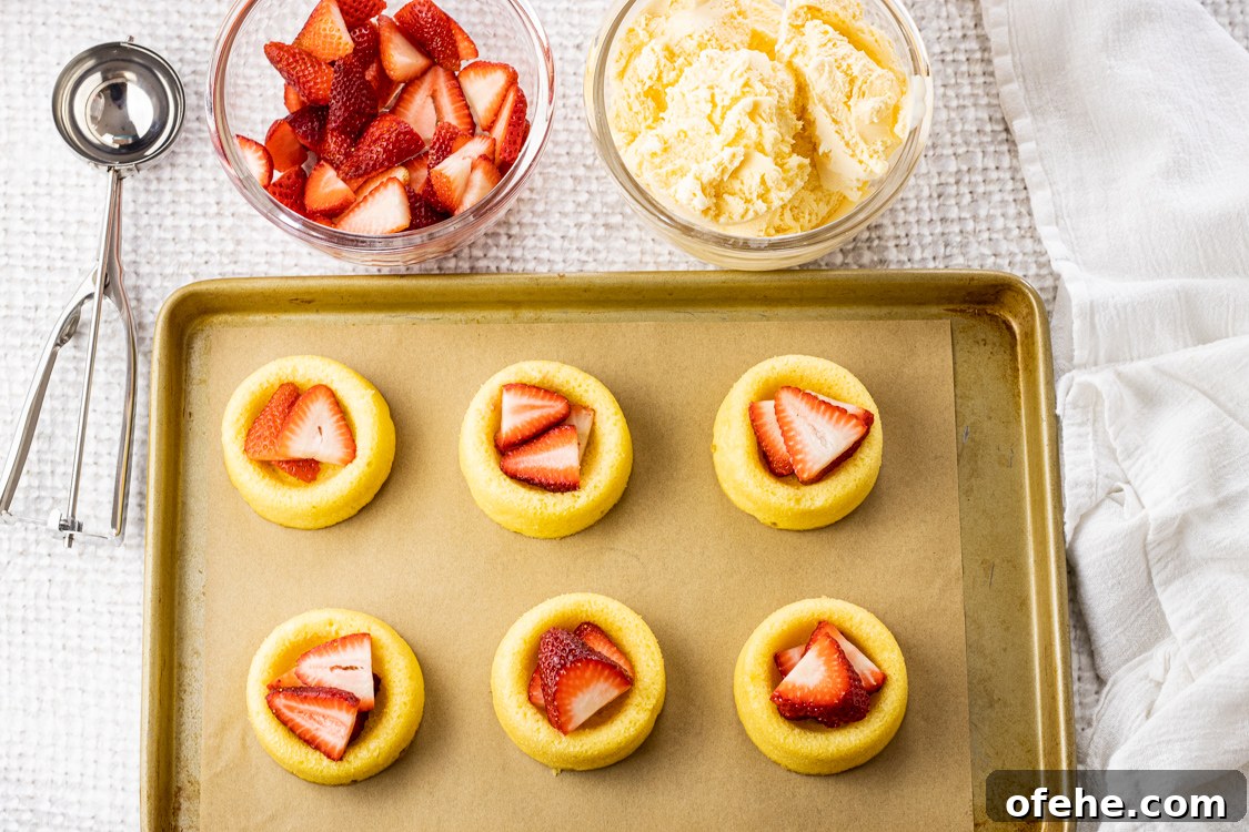 Classic Baked Alaska Recipe: Torched Meringue Dessert Guide 3 little angel food cakes topped with sliced strawberries