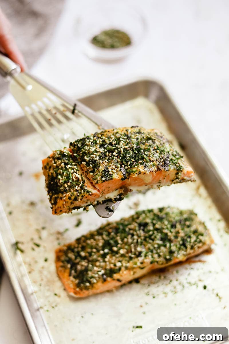20 Delicious Dishes to Pair with Asparagus 11 Baked salmon filet on a fish spatula with sprinkled furikake on top.