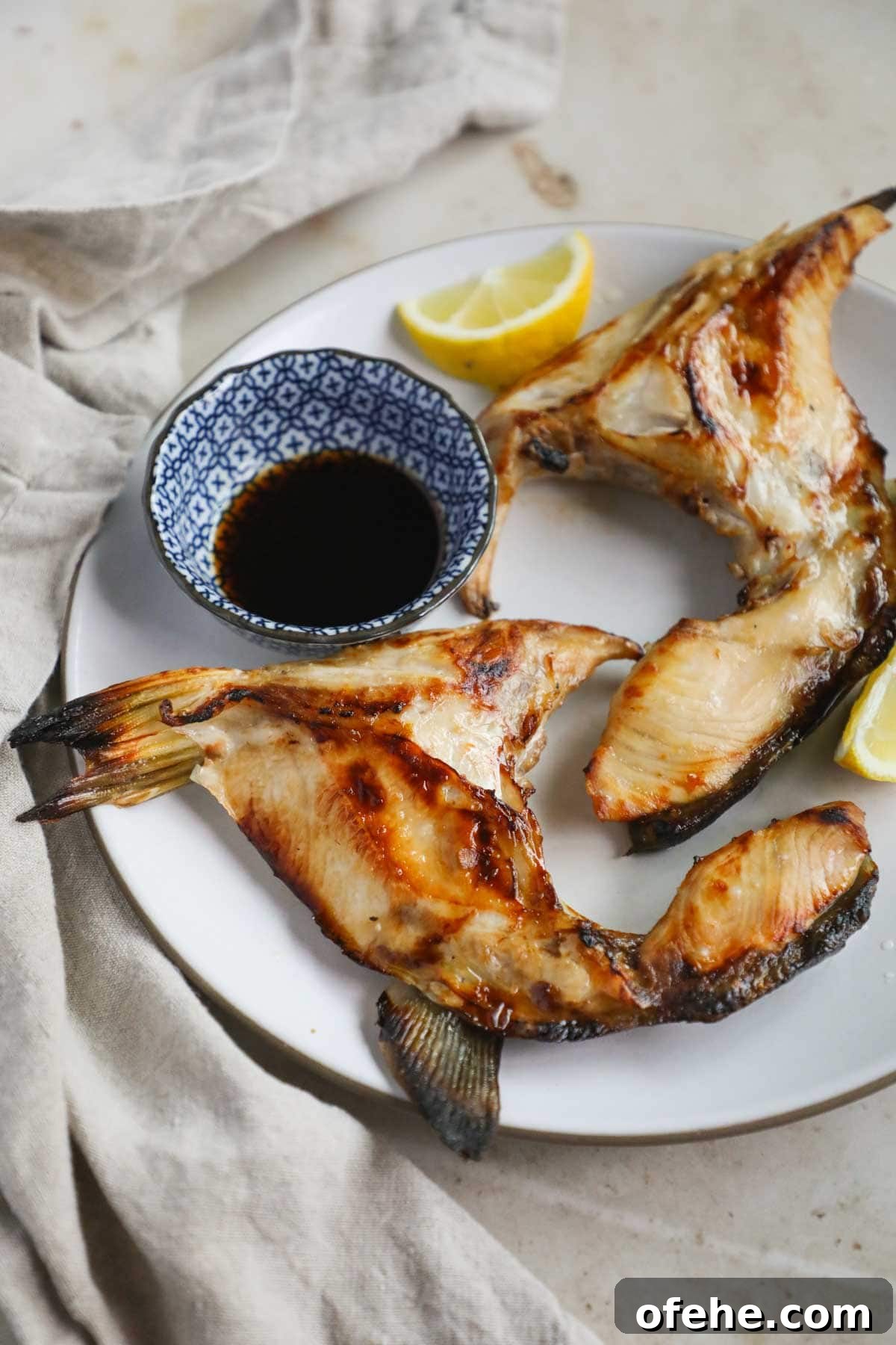 20 Delicious Dishes to Pair with Asparagus 21 Broiled Japanese hamachi kama (yellowtail collar) with mirin, lemon juice, and soy sauce on a plate.