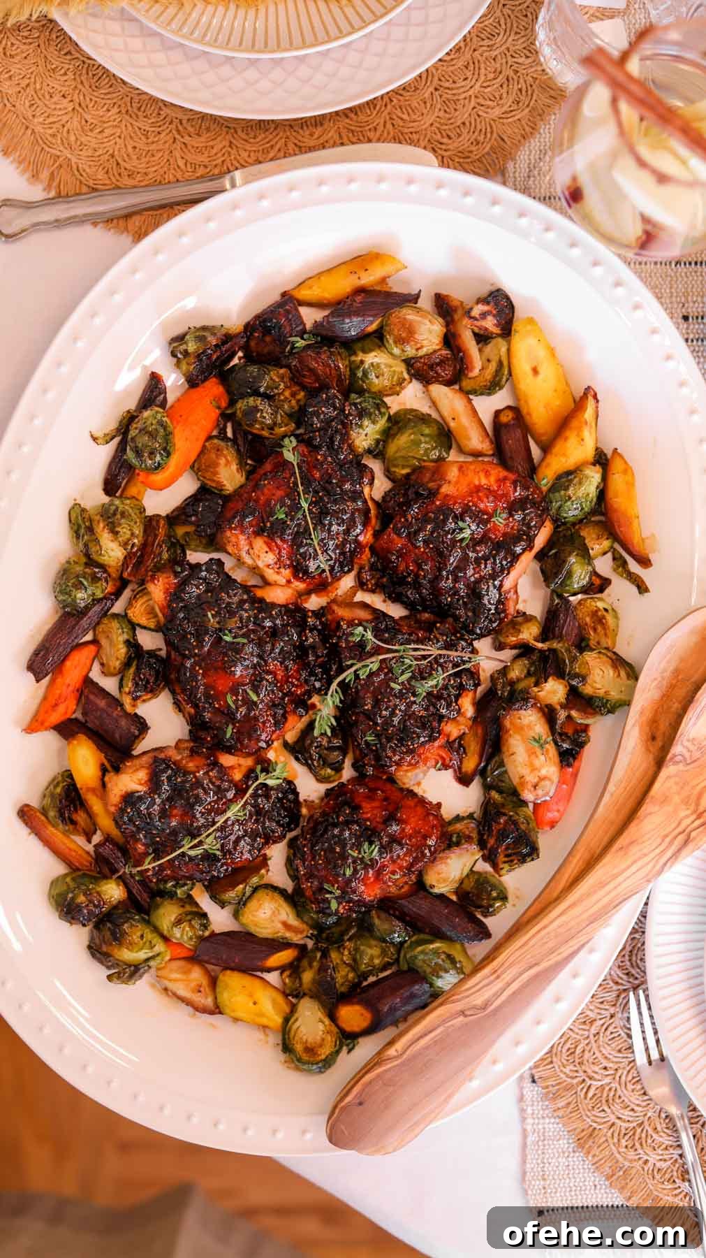 20 Delicious Dishes to Pair with Asparagus 22 Fig Balsamic Glazed Chicken on a white serving platter with an olive wood serving spoon.