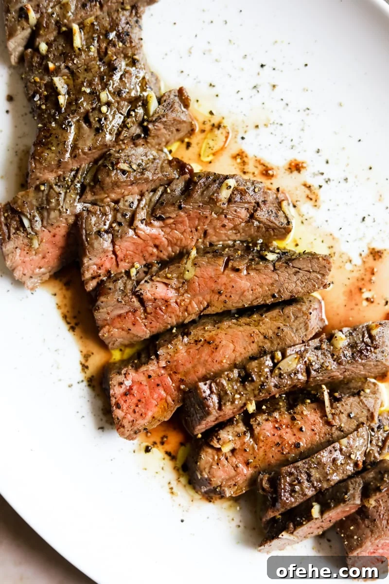20 Delicious Dishes to Pair with Asparagus 4 Bavette steak (garlic flank steak) sliced medium rare on a white plate au jus.