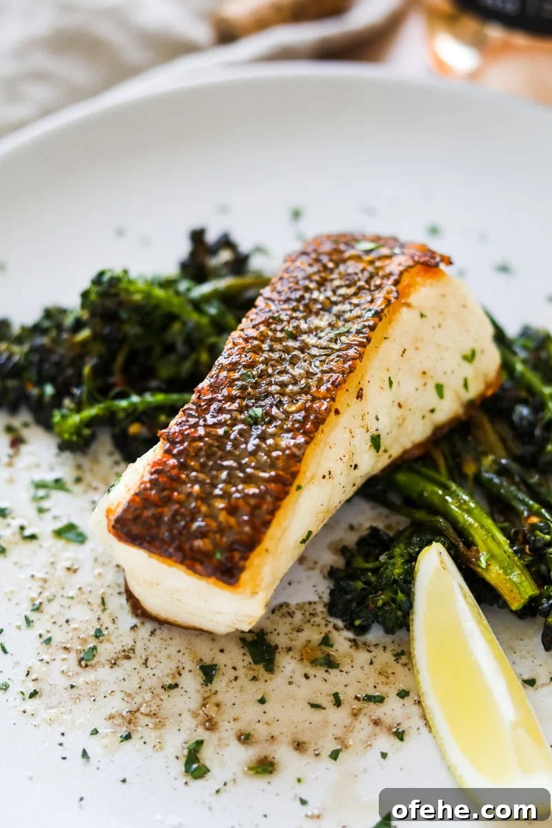 20 Delicious Dishes to Pair with Asparagus 5 Buttery lemon chilean sea bass with crispy skin on a plate with sautéed broccolini.