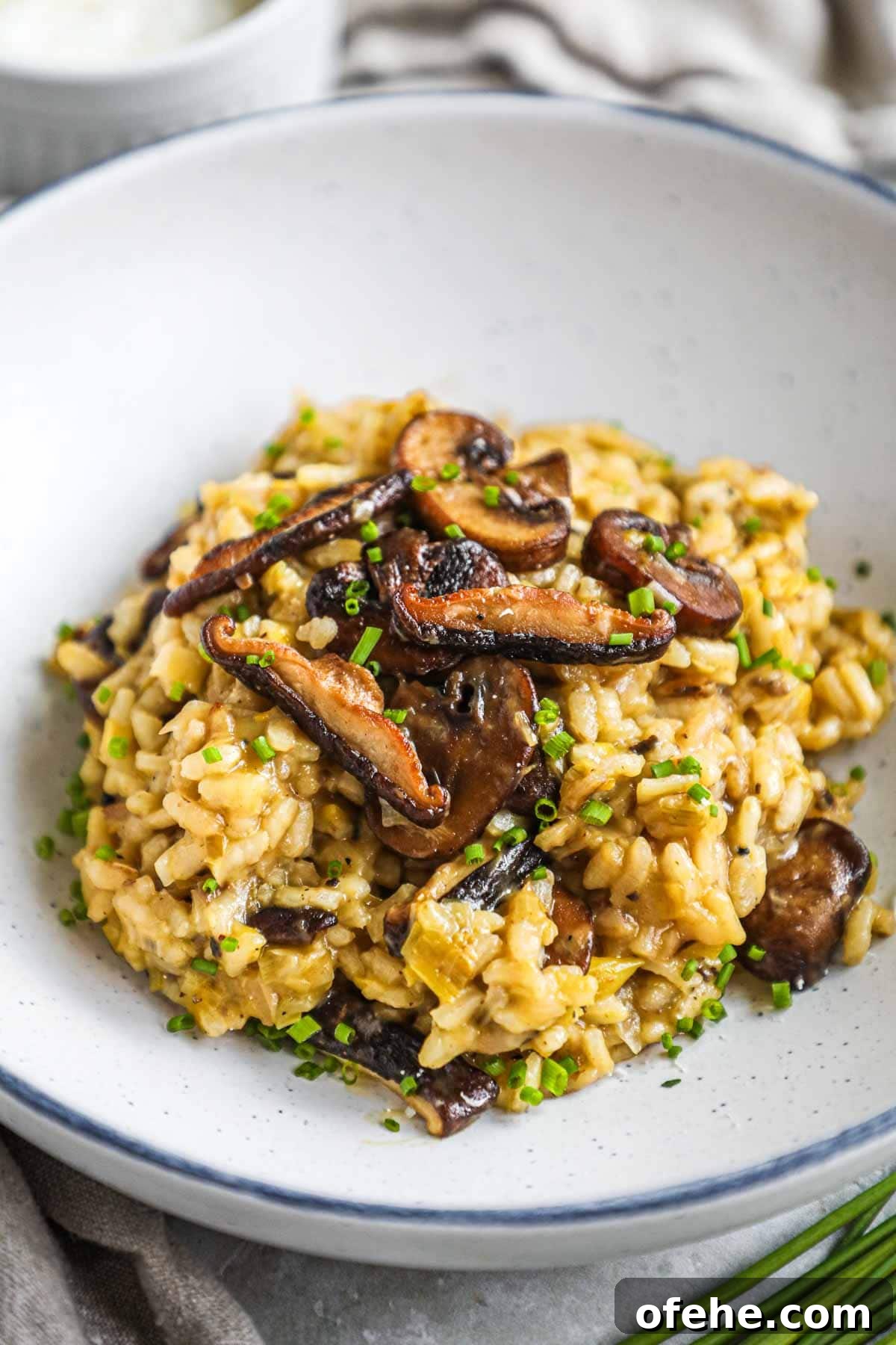 20 Delicious Dishes to Pair with Asparagus 8 truffle mushroom leek risotto in a bowl with sautéed crimini and shiitake mushrooms on top.