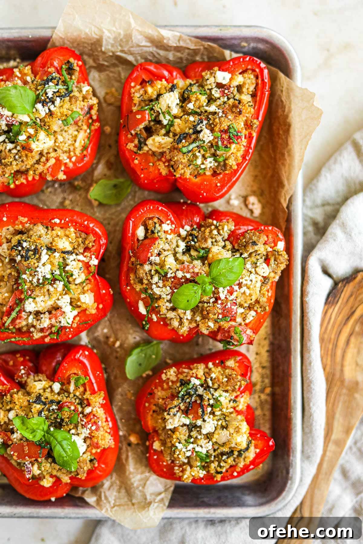 20 Delicious Dishes to Pair with Asparagus 9 Turkey and quinoa stuffed bell peppers with feta and basil on a baking sheet.