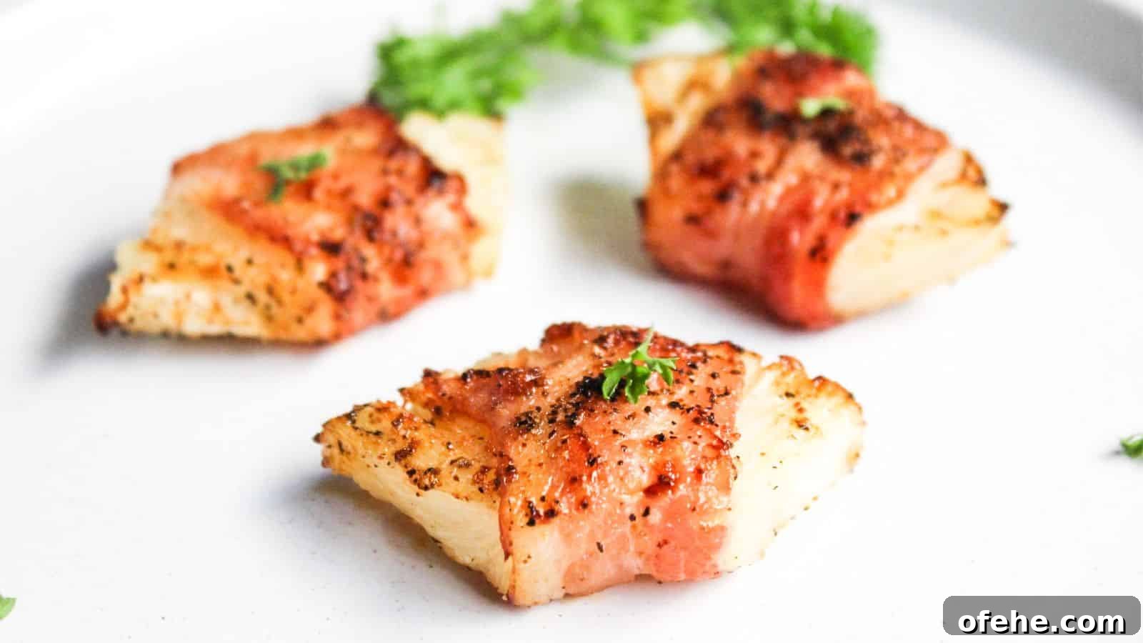 30 Quick Appetizers to Impress Guests Without Fuss 29 Bacon wrapped pineapple on a white plate.