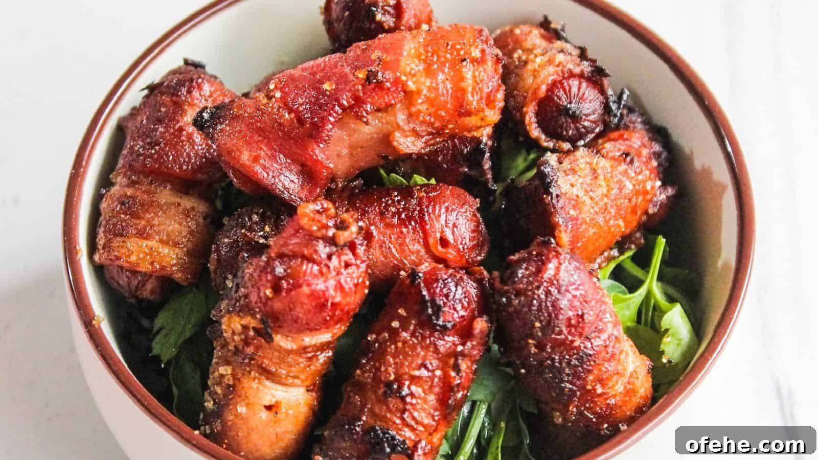 30 Quick Appetizers to Impress Guests Without Fuss 7 A bowl of bacon-wrapped cocktail sausages served on a bed of fresh green herbs.
