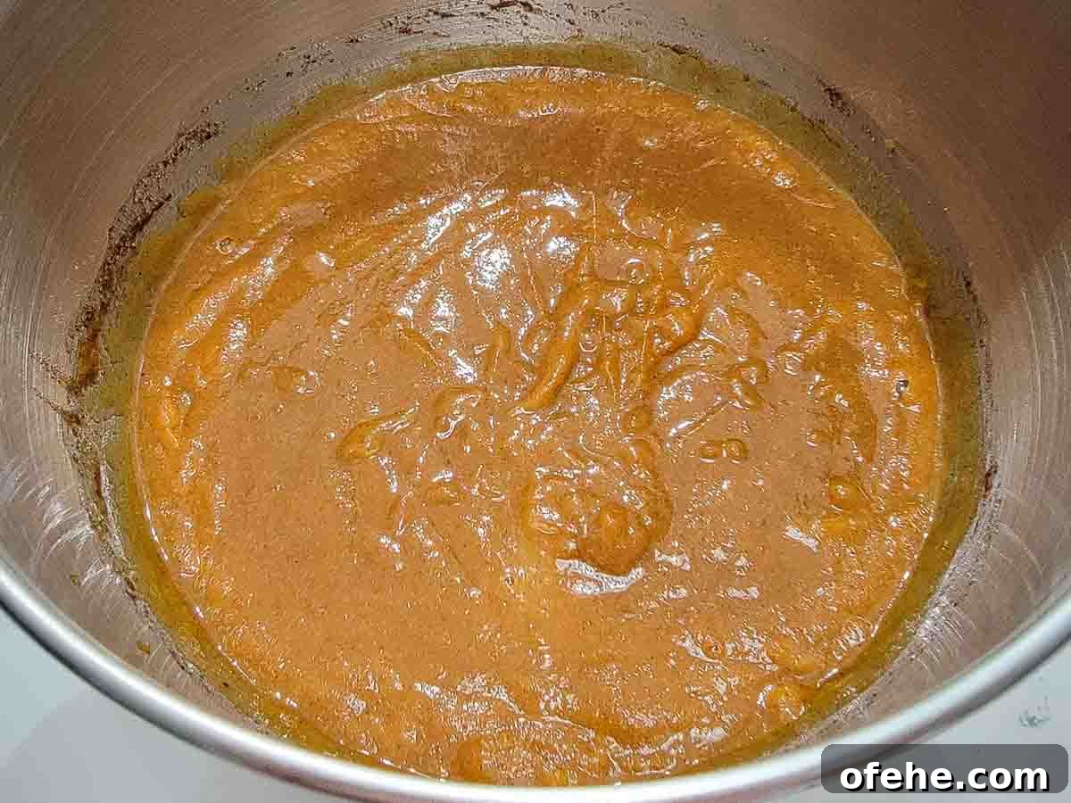 Ultimate Pumpkin Crisp Recipe for Fall Gatherings 3 canned pumpkin, sugar, eggs, pumpkin pie spice, salt, and vanilla extract mixed in a bowl.