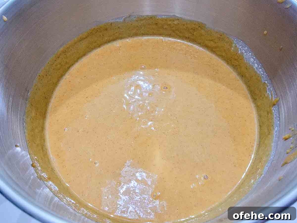 Ultimate Pumpkin Crisp Recipe for Fall Gatherings 4 heavy cream, canned pumpkin, sugar, eggs, pumpkin pie spice, salt, and vanilla extract mixed in a bowl.