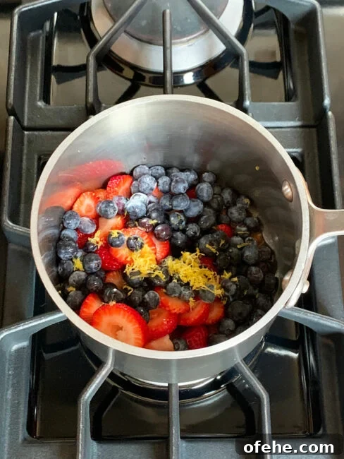 Fruit Compote Ideas: Delicious Pancake Toppers and More 5 Ingredients for berry compote in a saucepan on the stove.
